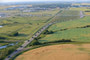 A single column of vehicles stretching from the Harvey Building to the Highway